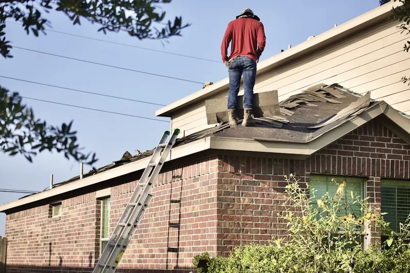 Professional roofer working on a residential roof in Post Road North